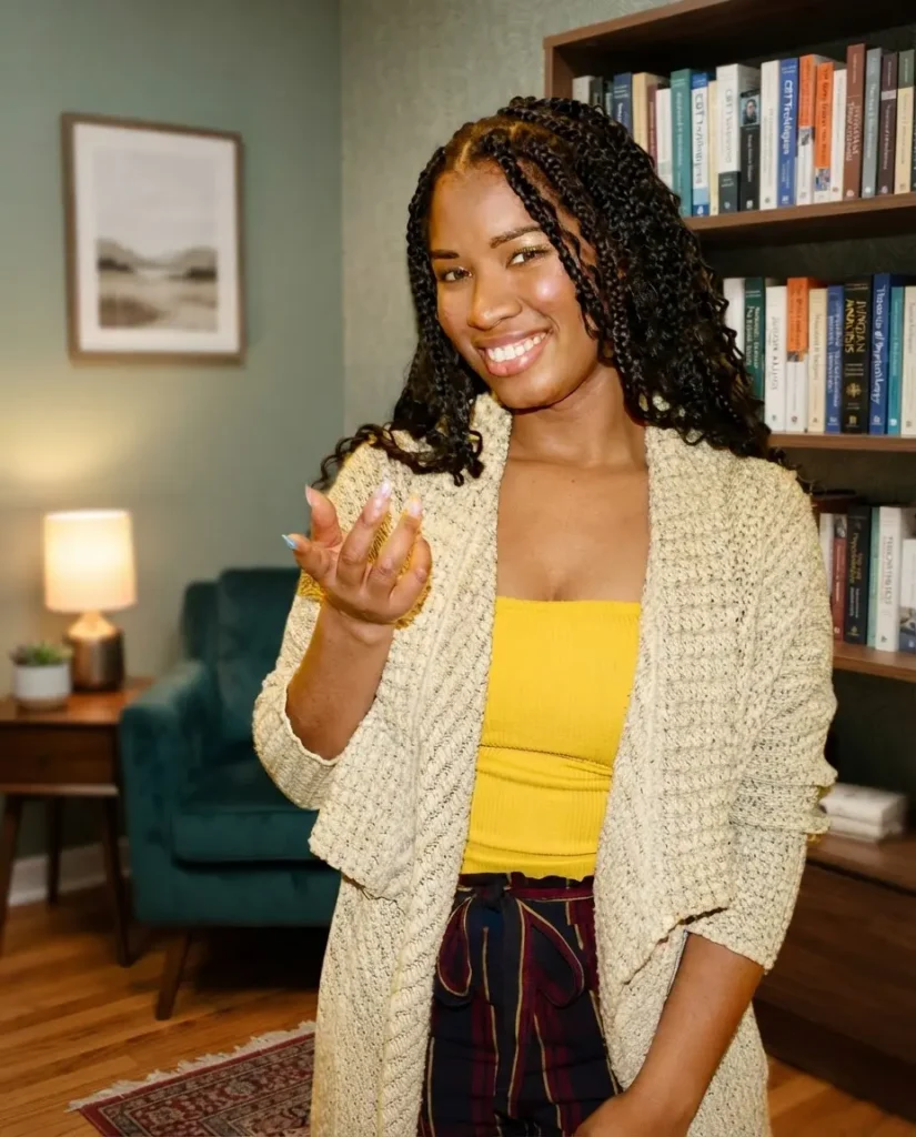 Smiling young woman in cozy office with bookshelves